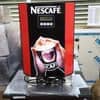 Nescafe coffee machine for office Noida with red front panel dispensing hot coffee