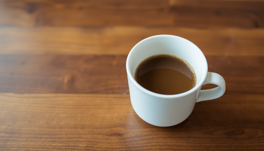 A cup of coffee premix with milk on a wooden table