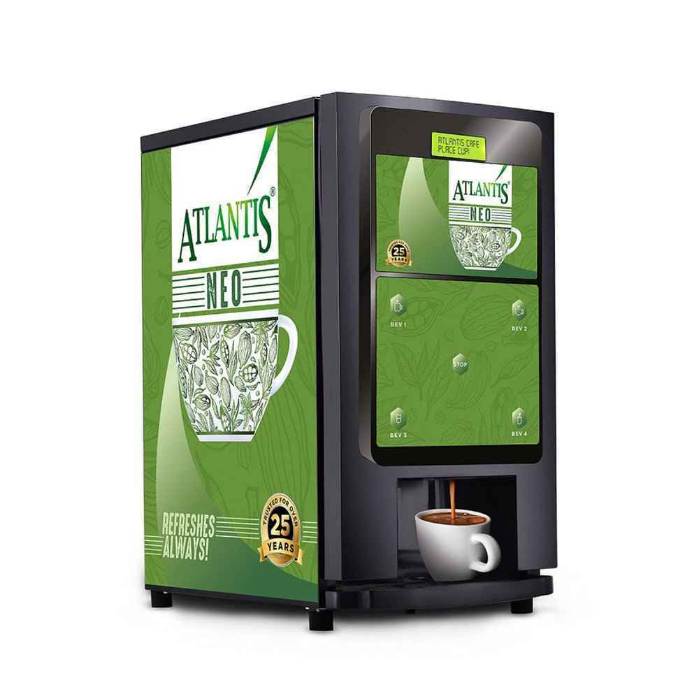 Atlantis Neo coin operated coffee vending machine with green panel and cup dispensing coffee