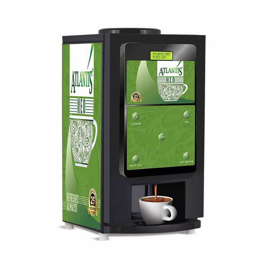 Atlantis Neo 4 lane coffee vending machine with black body and green decorative panels dispensing coffee