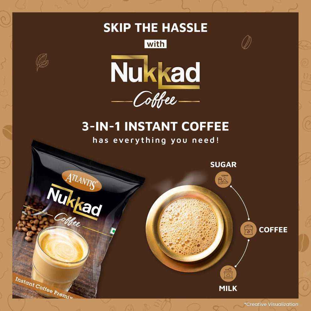 Atlantis Nukkad Instant Coffee Premix 1kg packet beside a cup of creamy coffee showing sugar milk and coffee mix