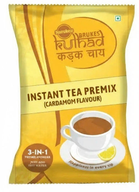 Coffee walla cardamom instant tea premix packet with 3-in-1 premix powder and cup of tea with lemon