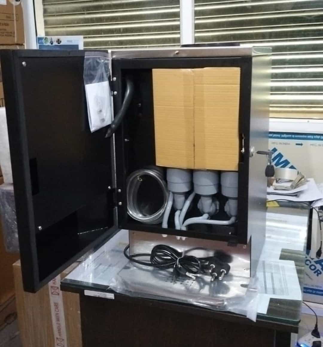 Nescafe 3 lane vending machine Delhi with open door showing internal components and cables