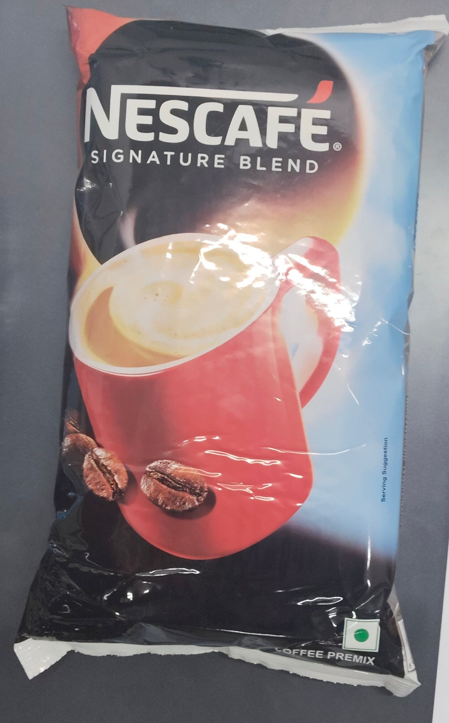Nescafe Signature Blend vending machine coffee pack with red cup and coffee beans on front