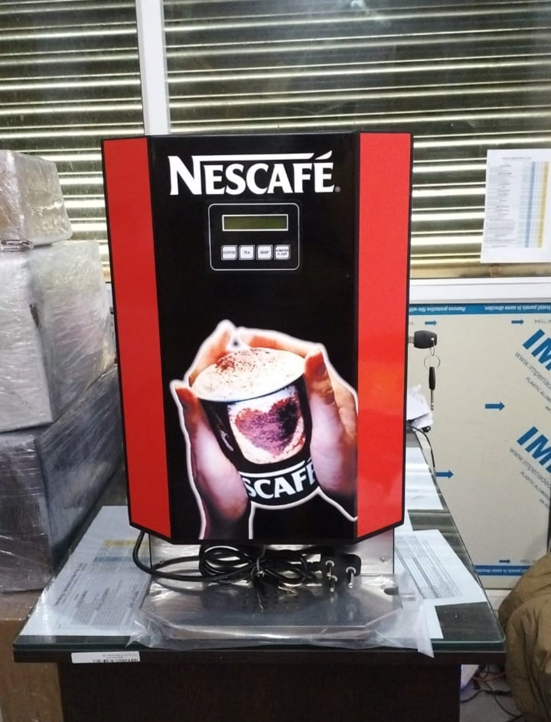 Nescafe vending machine with UPI payment option displaying a cup of coffee on front panel