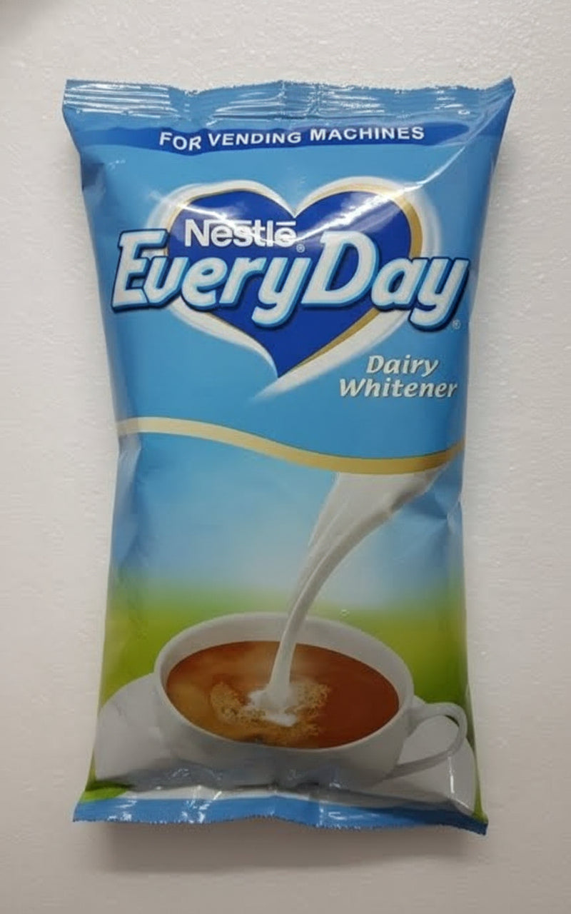 Nestle EveryDay dairy whitener 1kg packet with pouring milk over tea cup for vending machines
