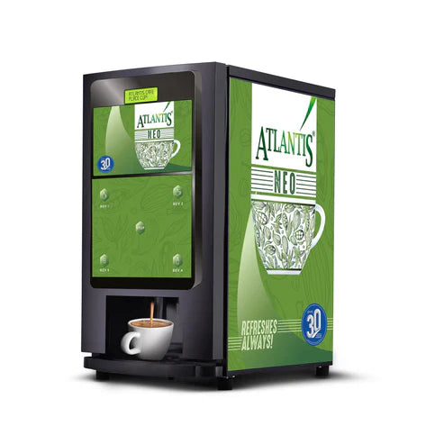 Atlantis NEO tea and coffee vending machine with green design dispensing coffee into a white cup